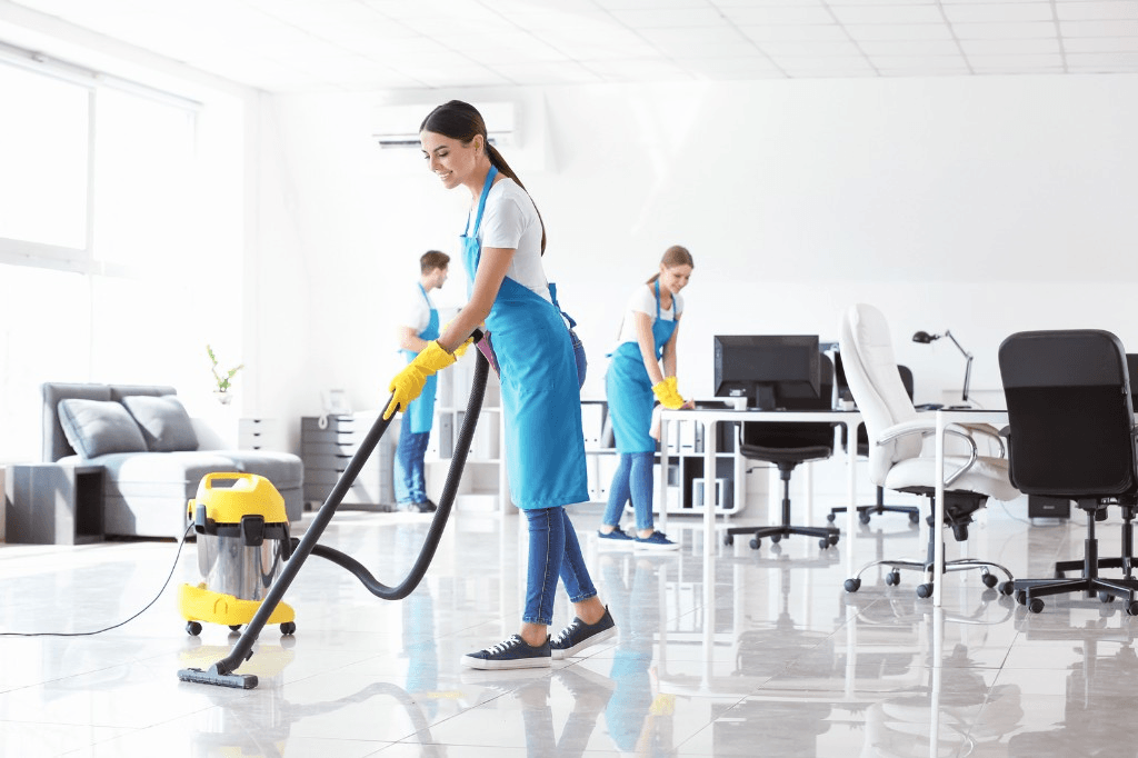 Cleaning team vacuuming and wiping down an office space